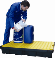 Man pouring chemicals into container on poly spill tray