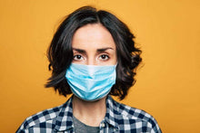 Load image into Gallery viewer, Woman wearing 3ply disposable face mask orange background for PPE Starter kit
